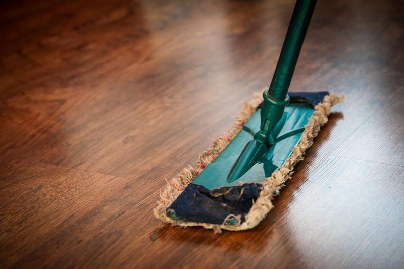Close-up of a floor being cleaned with a mop