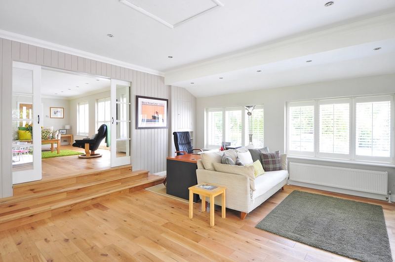 Sunlit living room with clean floors and tidy surfaces