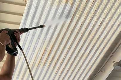 Pressure washer stripping dirt from exterior siding